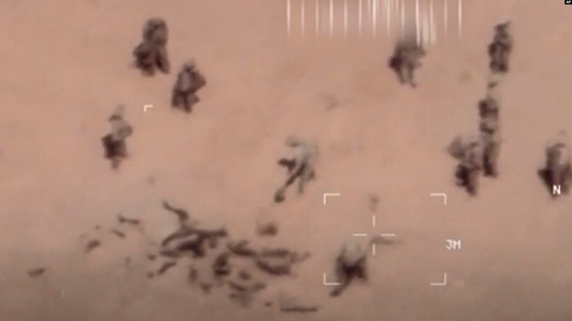Des images, prises par un drone, montrent des soldats s'affairer autour de cadavres qu'ils recouvrent de sable. (capture d'écran)